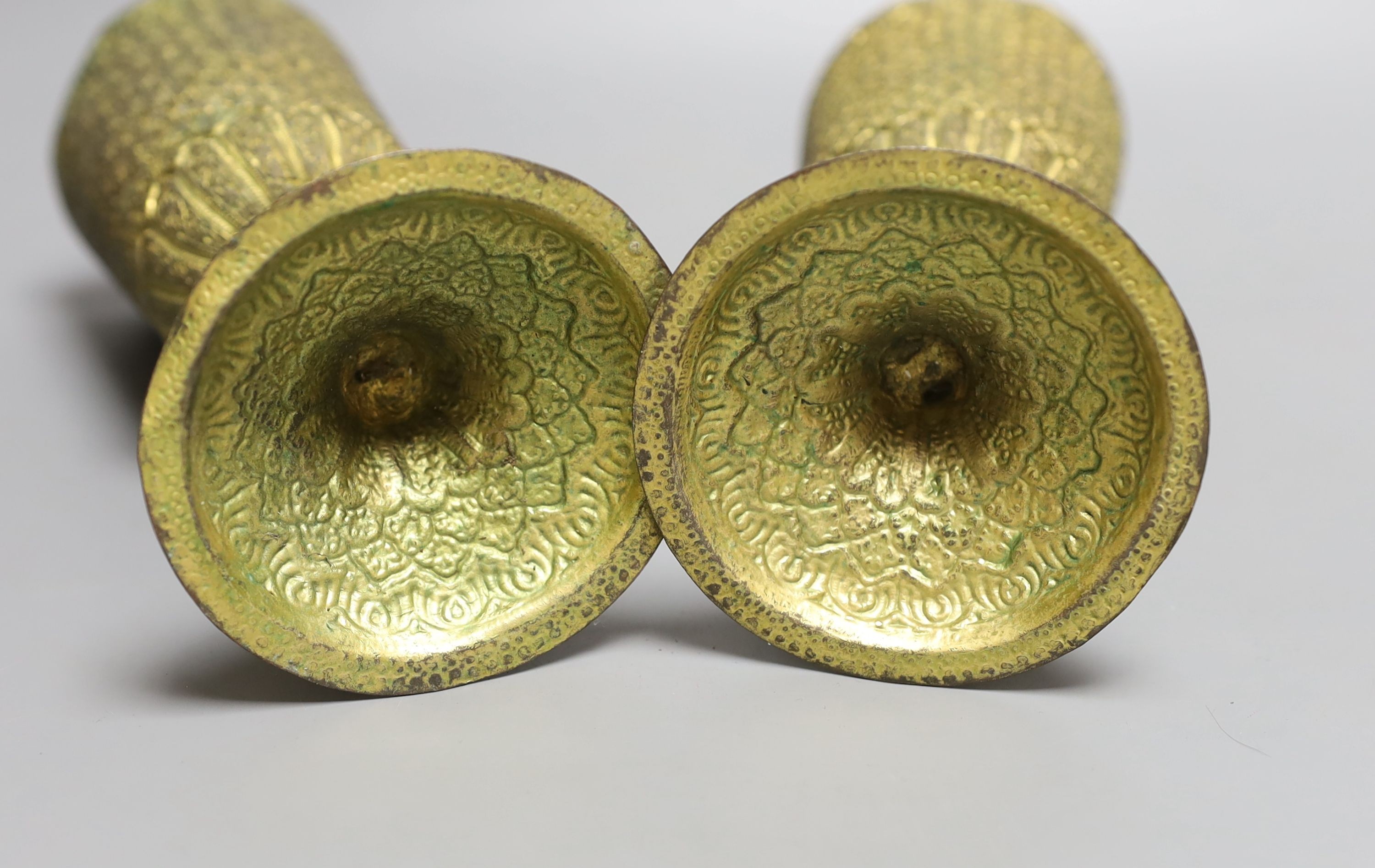 A pair of Middle Eastern repousse gilt metal goblets, 22cms high.